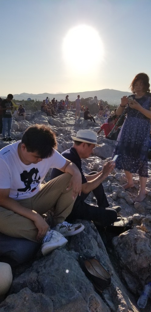 A photo of people hanging out at the top of Areopagus